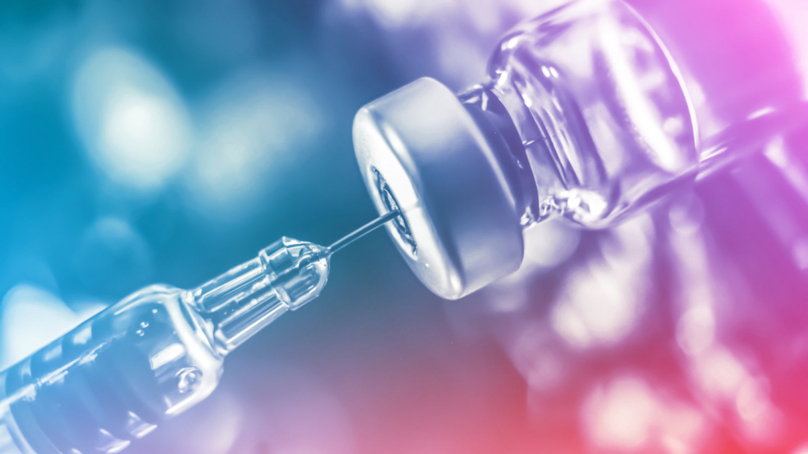 Close-up of a syringe drawing liquid from a glass vial, representing advanced peptide formulas for muscle recovery.