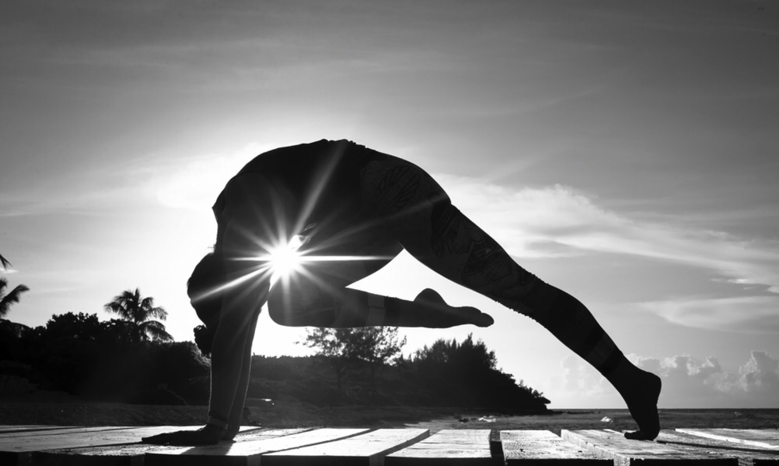 Health Wellness – person practicing yoga on beach at sunset, promoting health and wellbeing