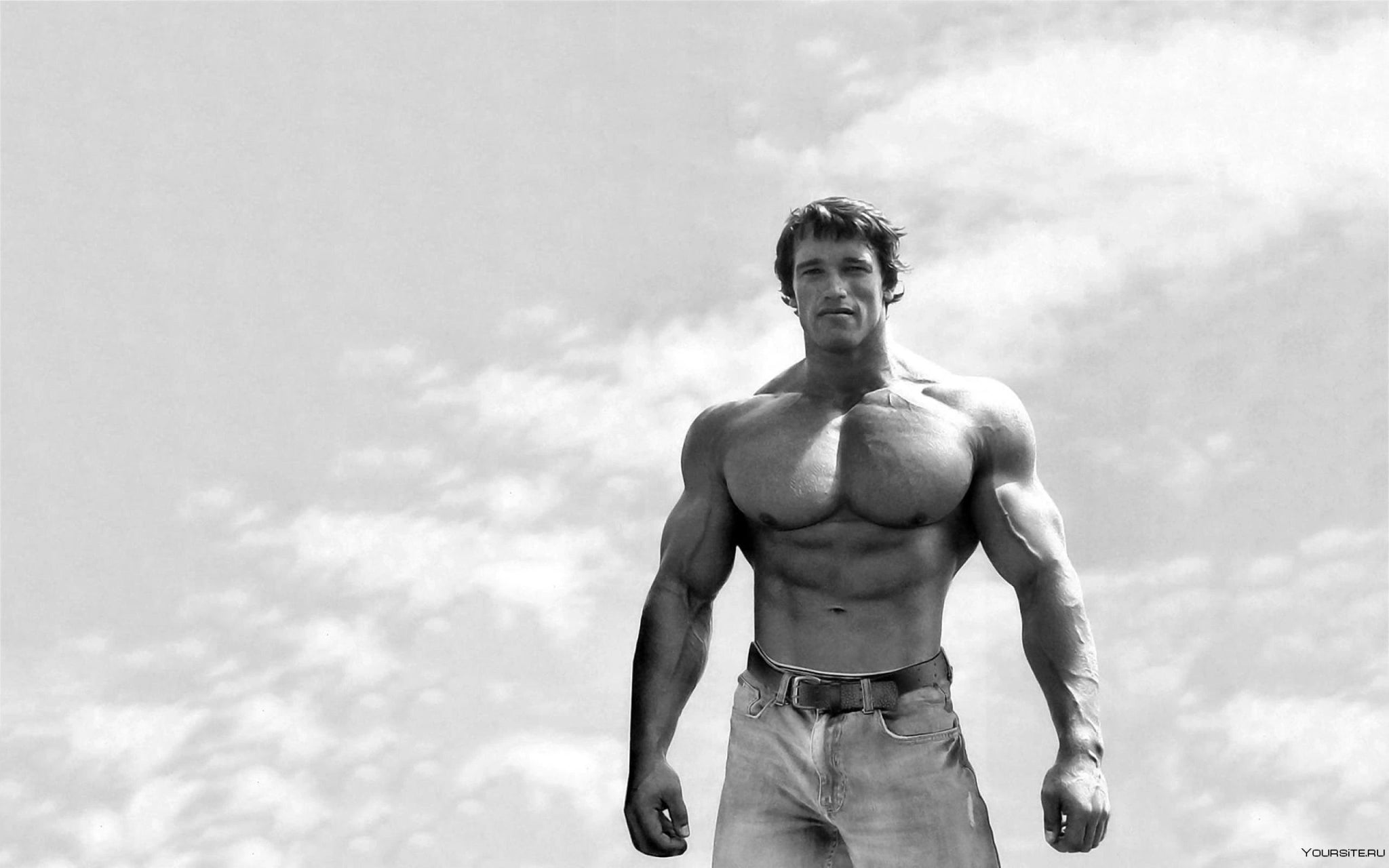 Muscular man posing outdoors, showcasing strength and fitness, representing sports nutrition for New Arrivals.